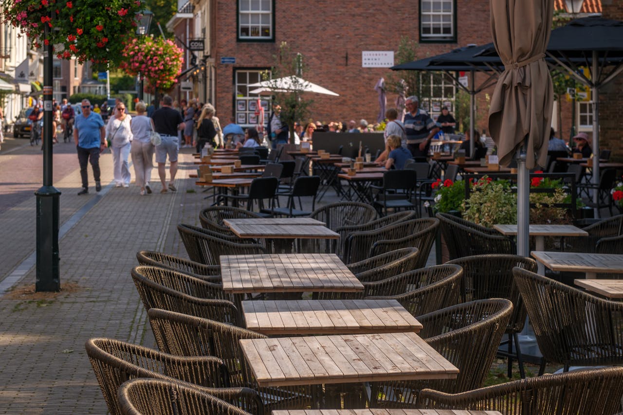 Charming outdoor cafe with stylish seating on a sunny day, perfect for a relaxing afternoon.